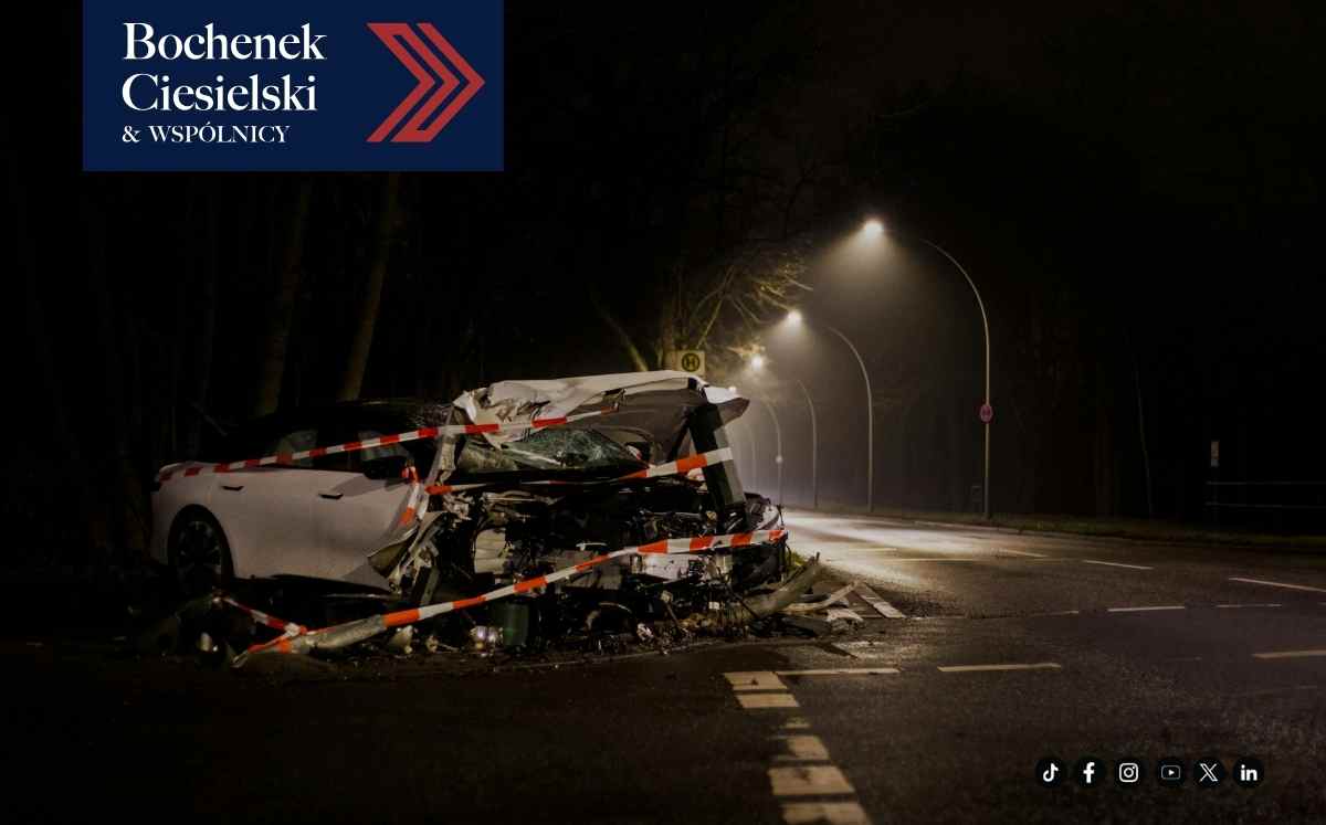 Poważnie uszkodzony samochód po wypadku na nocnej drodze, zabezpieczony taśmą