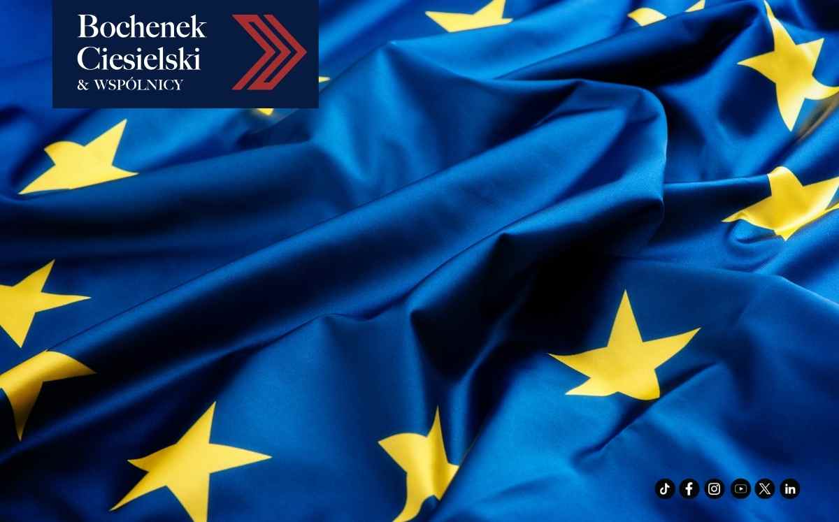 Flaga Unii Europejskiej z widocznymi złotymi gwiazdami na niebieskim tle, grafika kancelarii Bochenek Ciesielski & Wspólnicy.