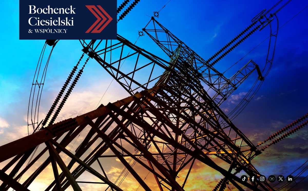 Electricity transmission tower silhouette against a colorful sunset sky, with Bochenek Ciesielski & Wspólnicy logo in the top-left corner.