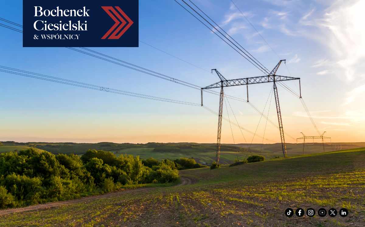 Słupy i linie energetyczne przebiegające przez teren rolny jako przykład infrastruktury przesyłowej na nieruchomości